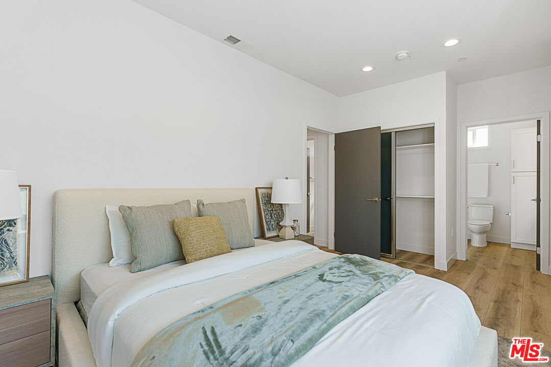 14652 West Sara Lane Panorama City, CA 91402 - Photo 16 of 33 a bedroom with a bed and a large mirror