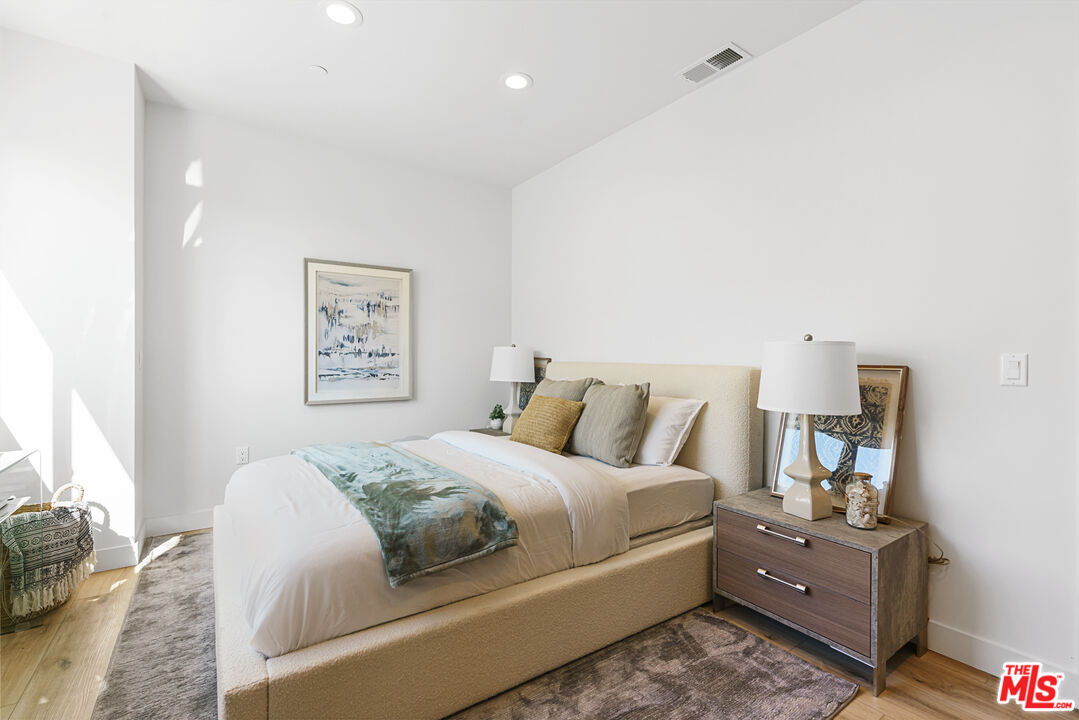 14652 West Sara Lane Panorama City, CA 91402 - Photo 17 of 33 a bedroom with a bed and a lamp on dresser