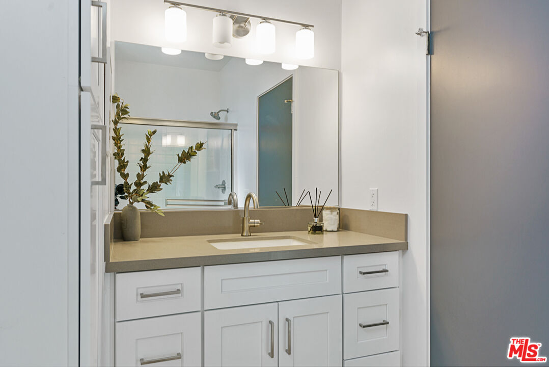 14652 West Sara Lane Panorama City, CA 91402 - Photo 19 of 33 a bathroom with a double vanity sink and mirror