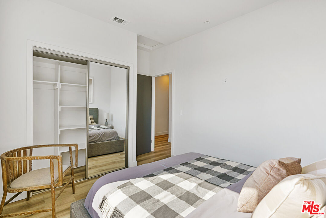 14652 West Sara Lane Panorama City, CA 91402 - Photo 21 of 33 a bedroom with a bed and a chair