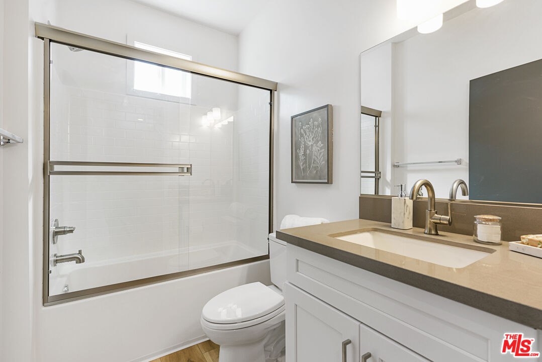 14652 West Sara Lane Panorama City, CA 91402 - Photo 24 of 33 a bathroom with a granite countertop sink mirror vanity and toilet