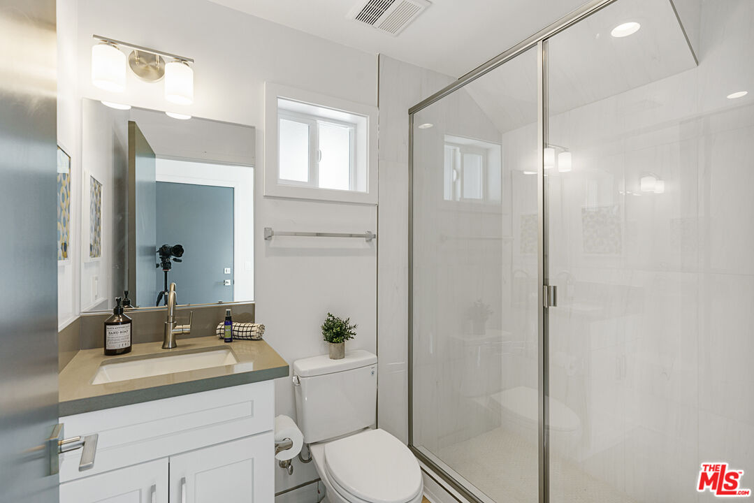 14652 West Sara Lane Panorama City, CA 91402 - Photo 26 of 33 a bathroom with a sink a toilet and shower