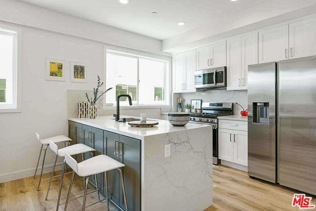 14652 West Sara Lane Panorama City, CA 91402 - Photo 9 of 33 a kitchen with a sink a counter top space appliances and cabinets