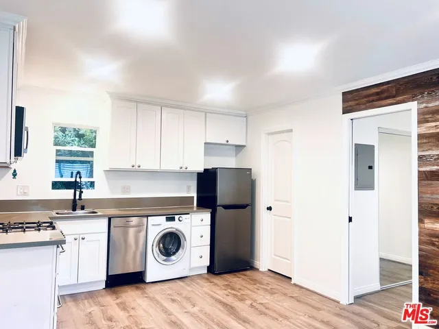 a utility room with sink dryer and washer