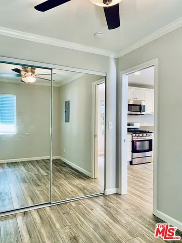 a view of a small space with wooden floor and a window