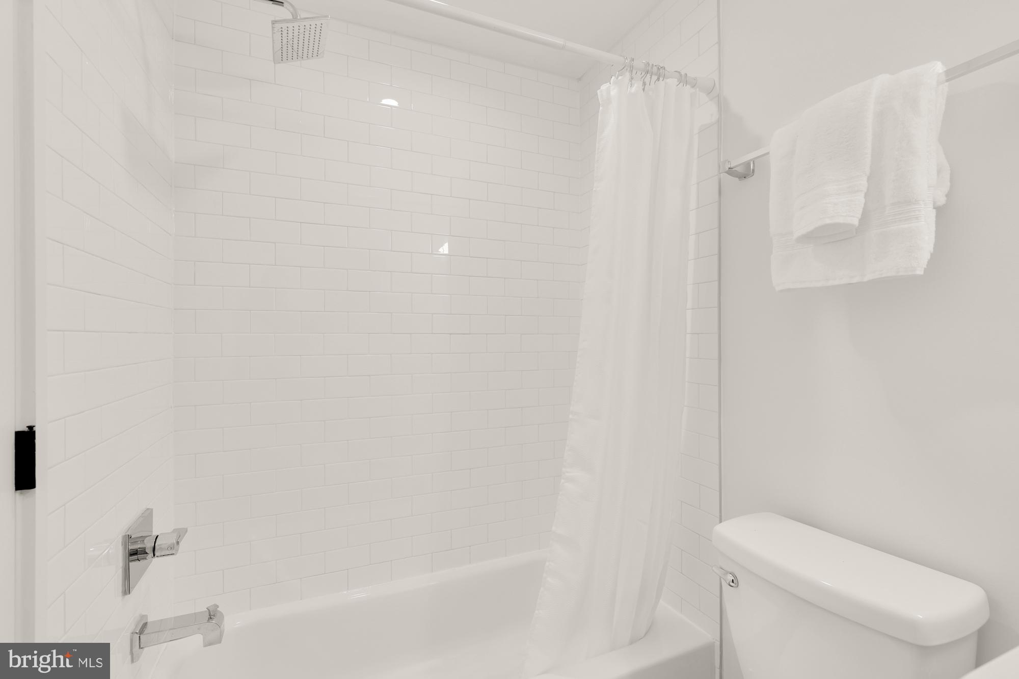 1171 3rd Street Northeast Washington, DC 20002 - Photo 16 of 27 a bathroom with a shower a toilet and a bathtub
