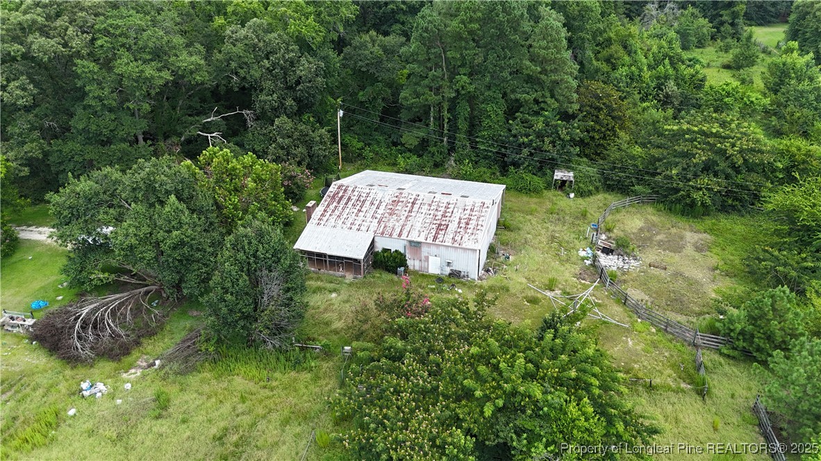 a view of a garden with a bench and trees