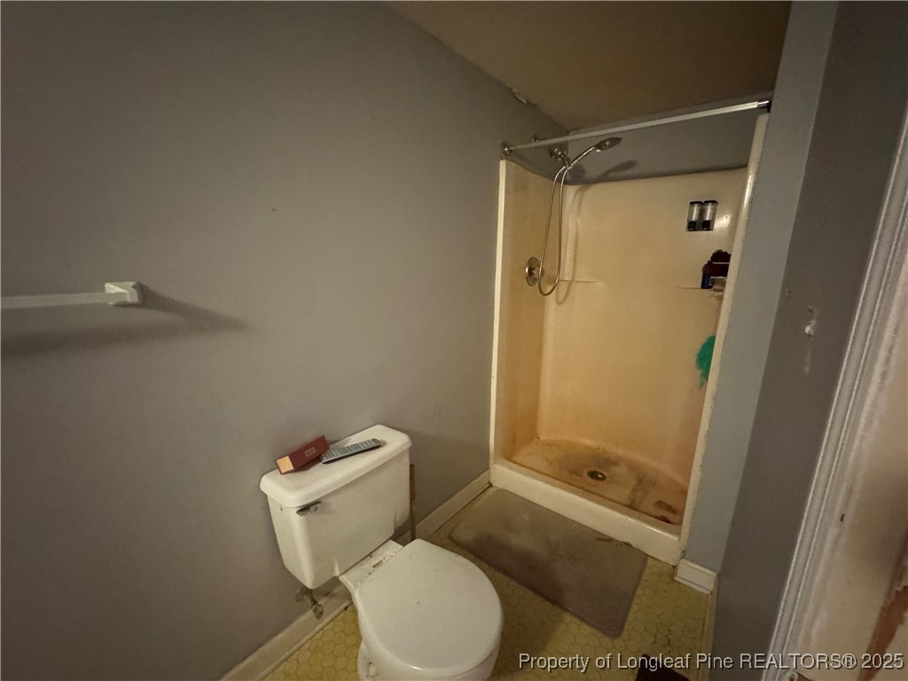 4199 Munsey Road Fayetteville, NC 28306 - Photo 14 of 24 a white toilet sitting next to a shower