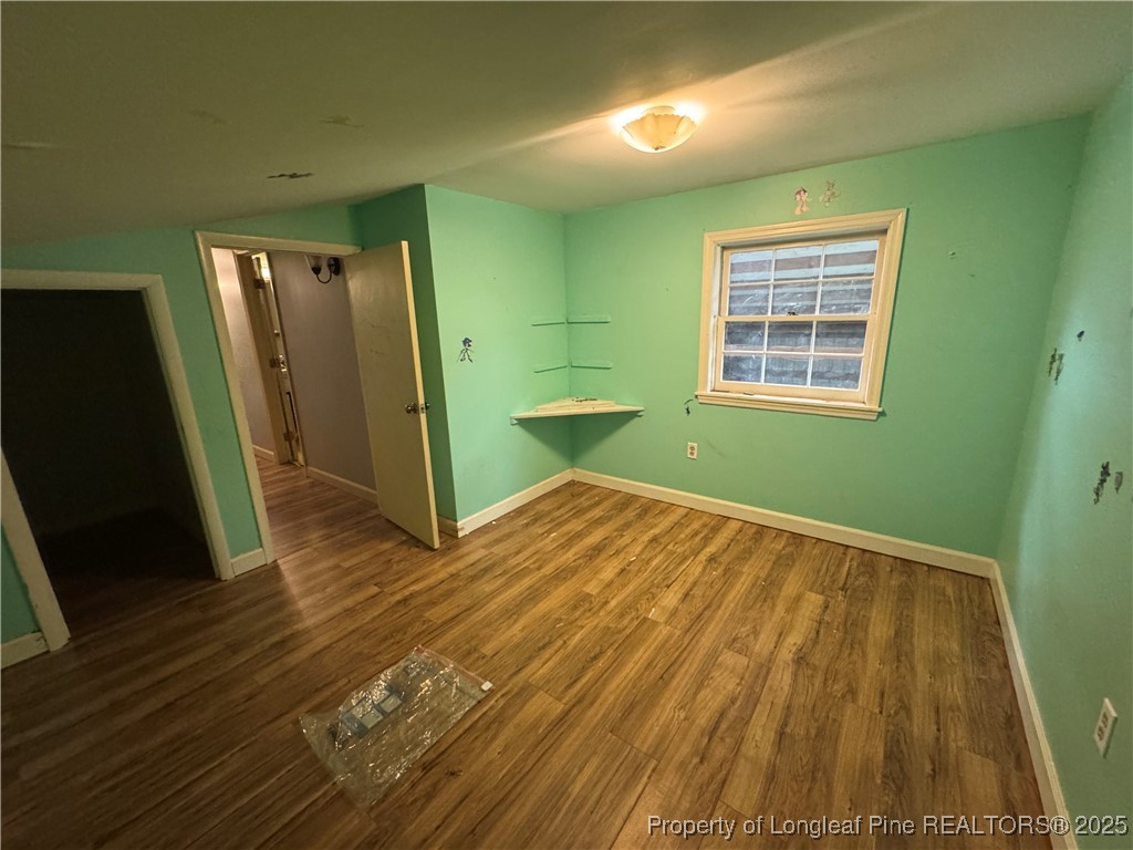 4199 Munsey Road Fayetteville, NC 28306 - Photo 15 of 24 a view of a room with wooden floor and a bathroom
