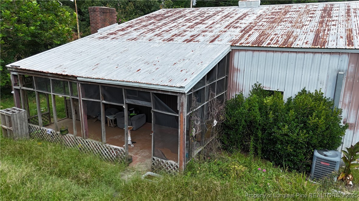 4199 Munsey Road Fayetteville, NC 28306 - Photo 3 of 24 a backyard with potted plants and wooden fence