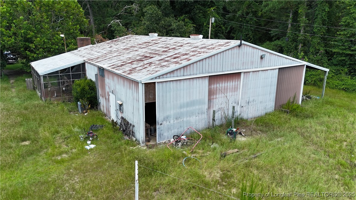 4199 Munsey Road Fayetteville, NC 28306 - Photo 4 of 24 a wooden house with lots of trees