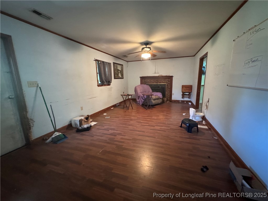 4199 Munsey Road Fayetteville, NC 28306 - Photo 8 of 24 a view of a livingroom with hardwood floor and a ceiling fan