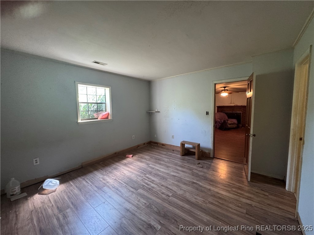 4199 Munsey Road Fayetteville, NC 28306 - Photo 9 of 24 a view of empty room with wooden floor and fan