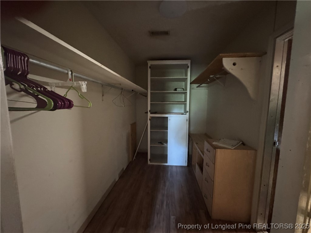 4199 Munsey Road Fayetteville, NC 28306 - Photo 10 of 24 a view of walk in closet with clothes and shoes