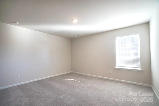 a view of an empty room and a window