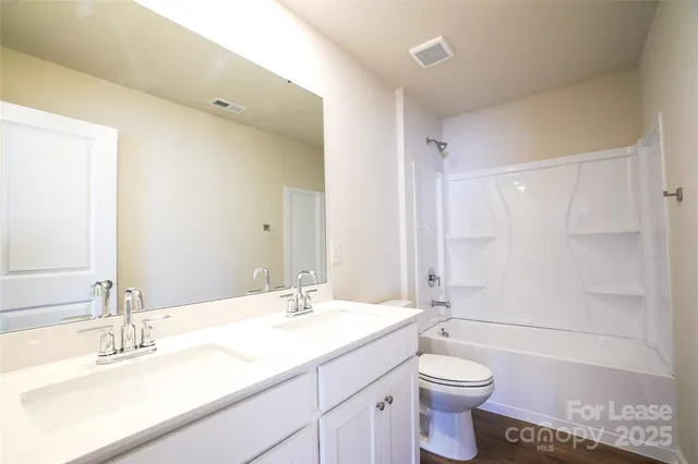 a view of a room with a ceiling fan and a window
