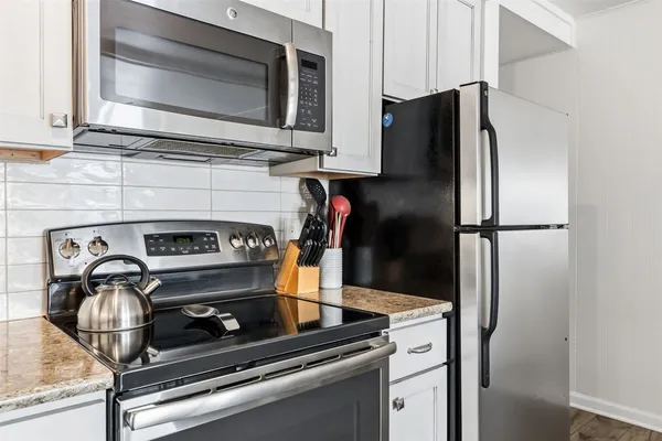 a kitchen with a stove and a microwave