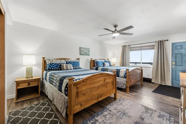 a bedroom with bed and a chandelier