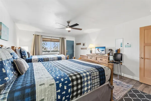 a bedroom with a large bed a window and dresser