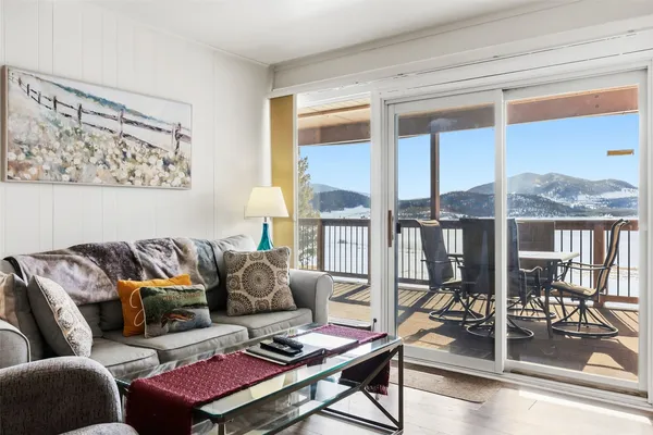 a living room with furniture and a floor to ceiling window