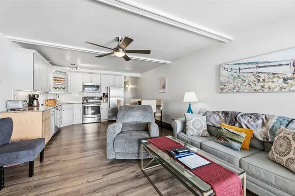 a living room with furniture and kitchen view