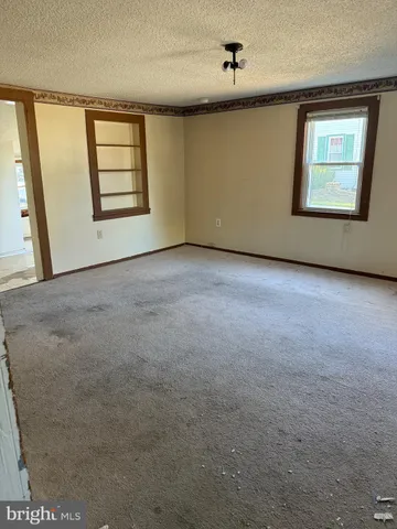 an empty room with windows and closet