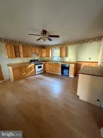 a kitchen with stainless steel appliances a stove a microwave a sink and cabinets