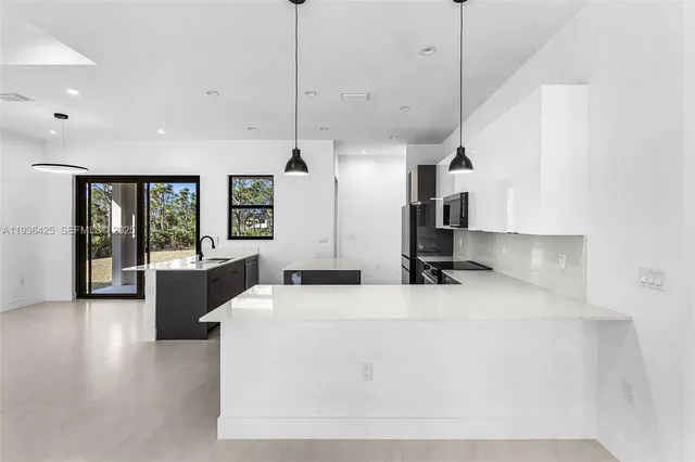 a kitchen with stainless steel appliances kitchen island a large island in the center