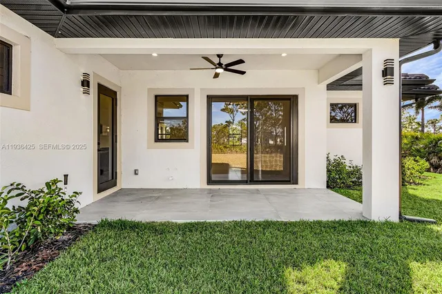 a view of a big room with windows and chandelier