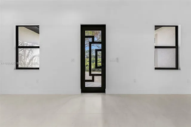 an empty room with windows and closet