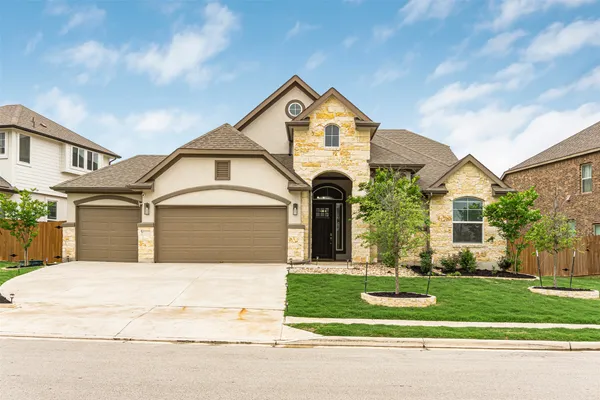 a front view of a house with a yard