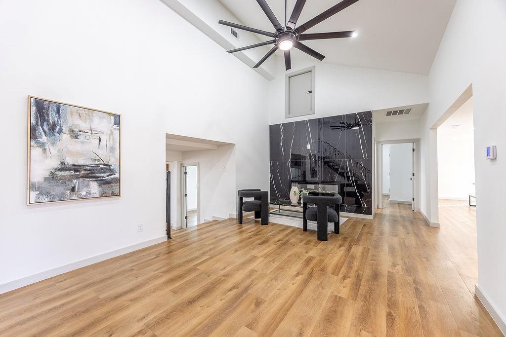 8713 Clay Hibbins Road Keller, TX 76248 - Photo 16 of 40 a view of an empty room with wooden floor and a ceiling fan
