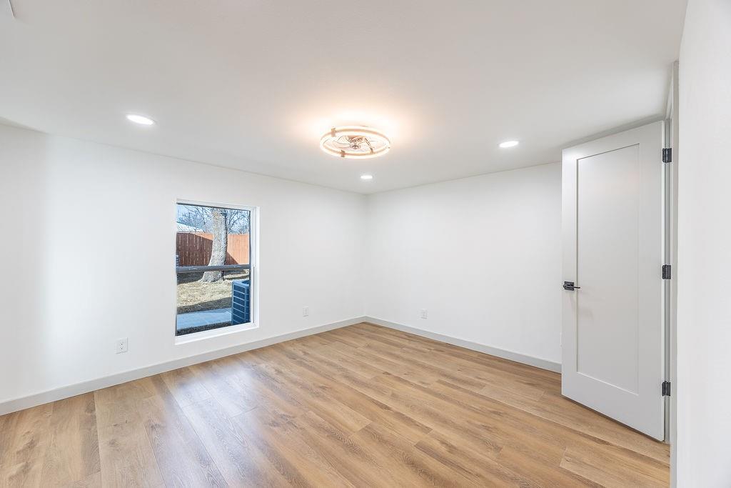 8713 Clay Hibbins Road Keller, TX 76248 - Photo 21 of 40 wooden floor in an empty room with a window
