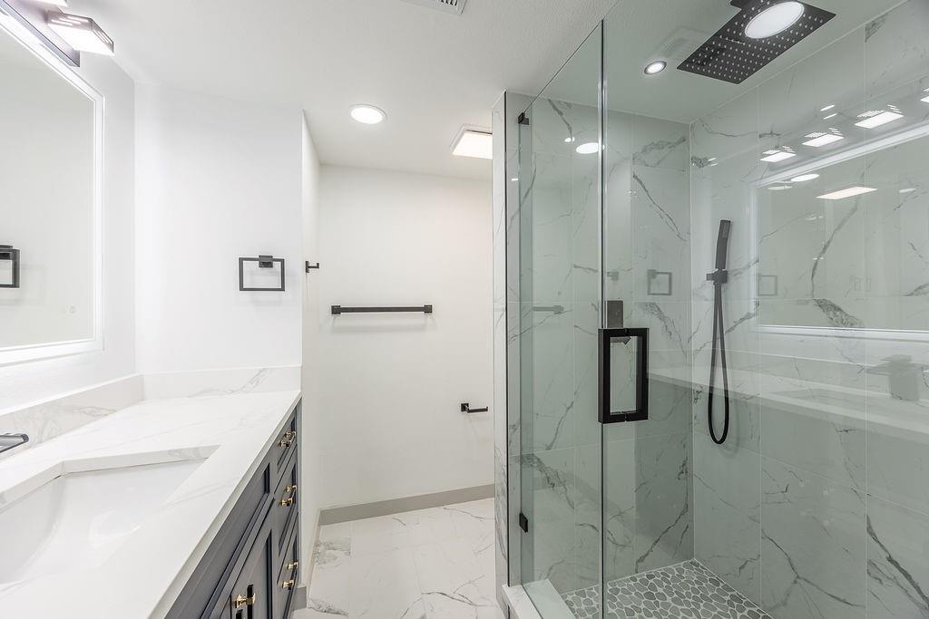 8713 Clay Hibbins Road Keller, TX 76248 - Photo 23 of 40 a bathroom with a shower sink and mirror