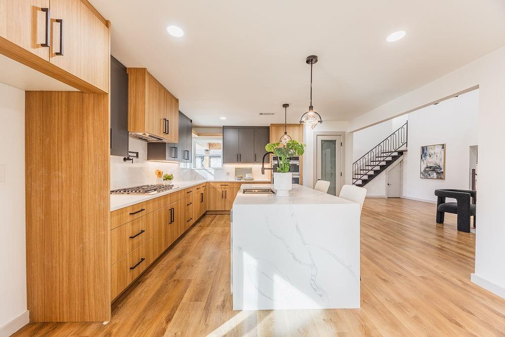 8713 Clay Hibbins Road Keller, TX 76248 - Photo 27 of 40 a large white kitchen with kitchen island sink refrigerator and stove
