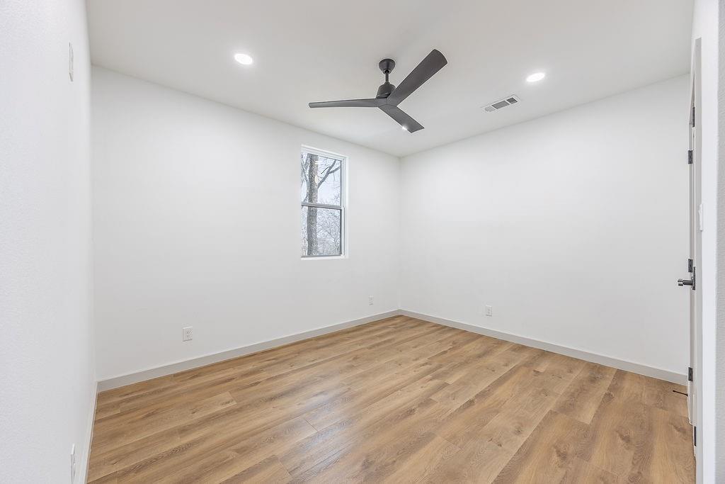 8713 Clay Hibbins Road Keller, TX 76248 - Photo 35 of 40 wooden floor in an empty room with a window