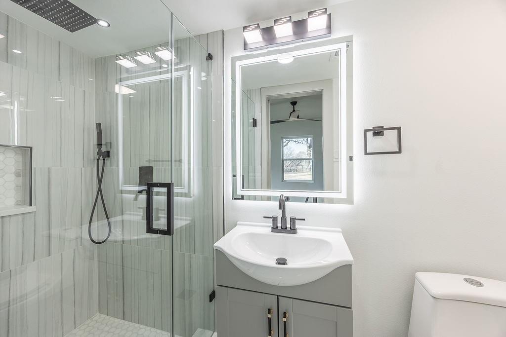 8713 Clay Hibbins Road Keller, TX 76248 - Photo 37 of 40 a bathroom with a sink a light fixture and a mirror