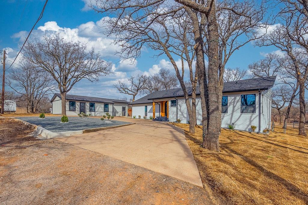 8713 Clay Hibbins Road Keller, TX 76248 - Photo 9 of 40 a front view of a building with a garden