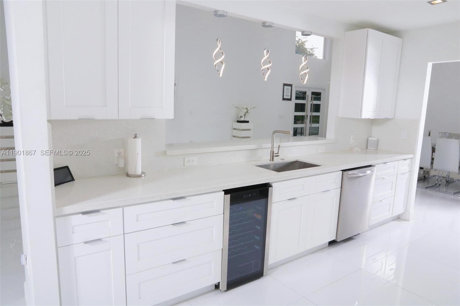 6003 Umbrella Tree Lane Tamarac, FL 33319 - Photo 13 of 22 a kitchen with white cabinets