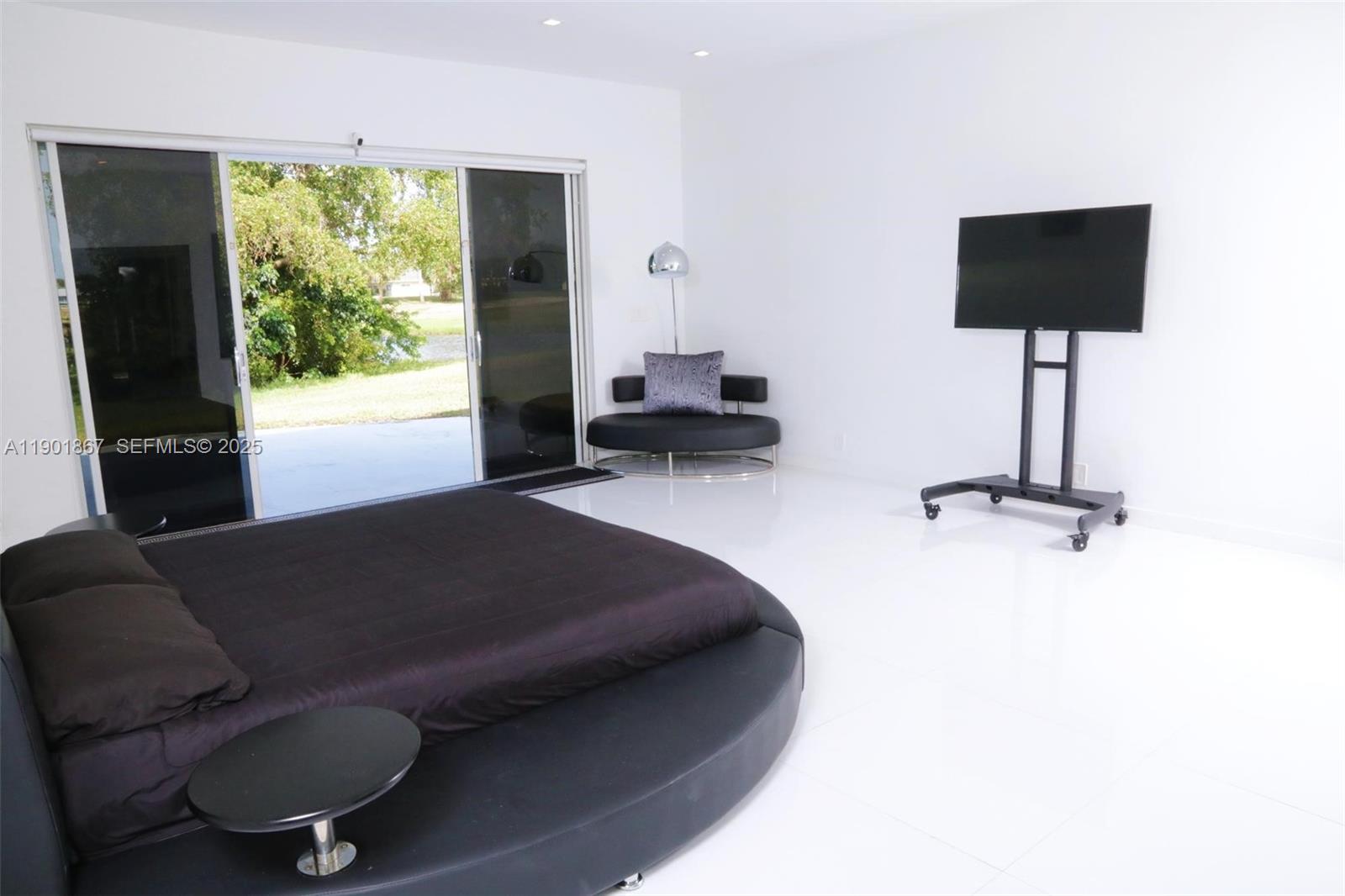 6003 Umbrella Tree Lane Tamarac, FL 33319 - Photo 16 of 22 a living room with furniture and a flat screen tv