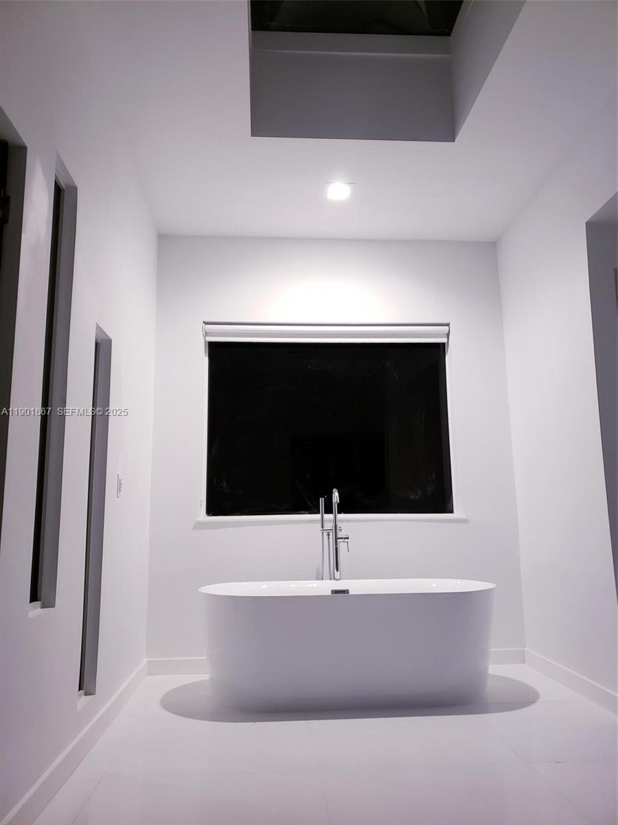 6003 Umbrella Tree Lane Tamarac, FL 33319 - Photo 18 of 22 a bathroom with a bathtub