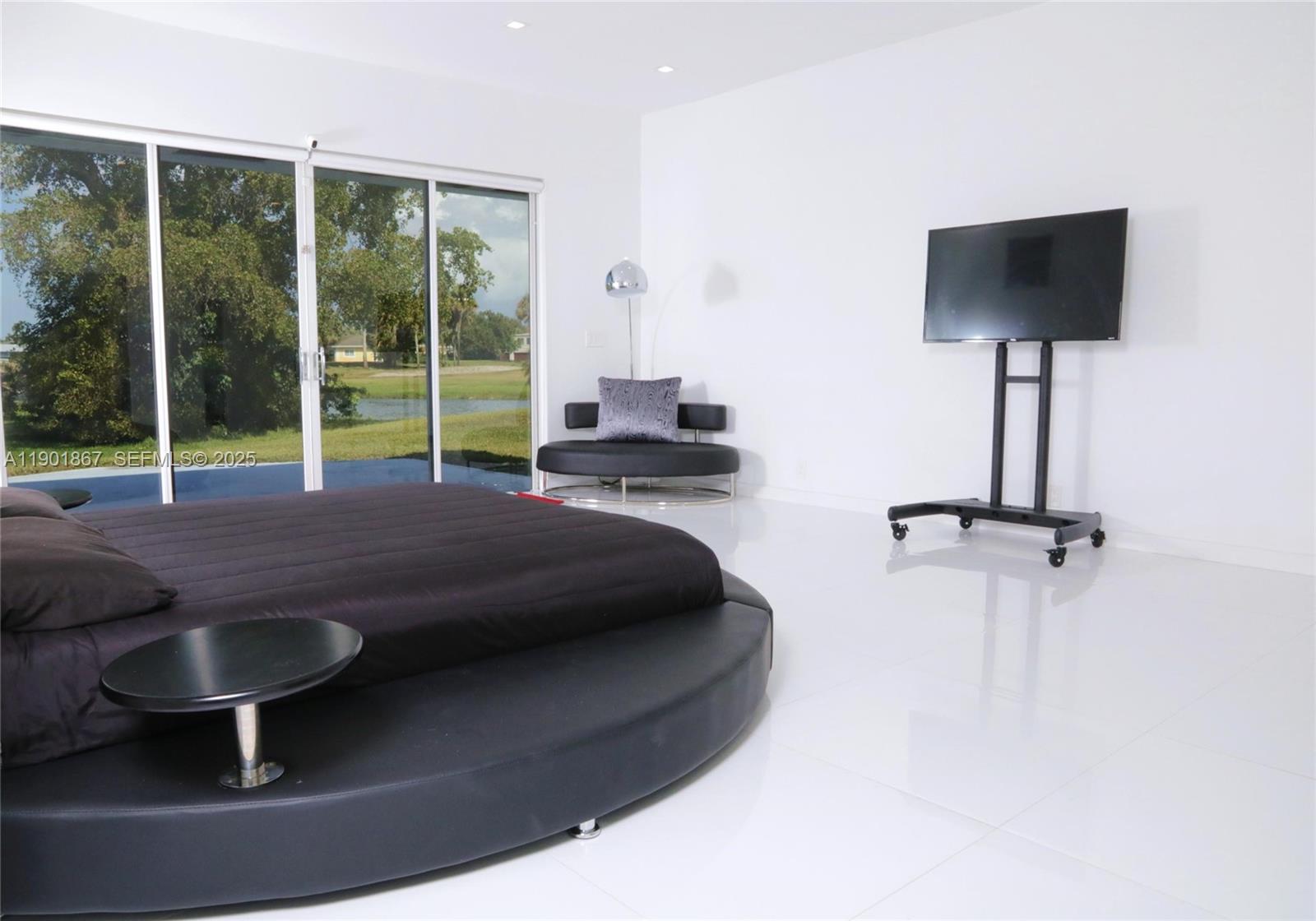 6003 Umbrella Tree Lane Tamarac, FL 33319 - Photo 19 of 22 a room with furniture and a flat screen tv