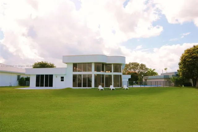 a front view of house with yard and green space