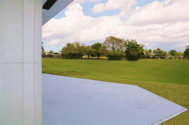 a view of a field with a big yard