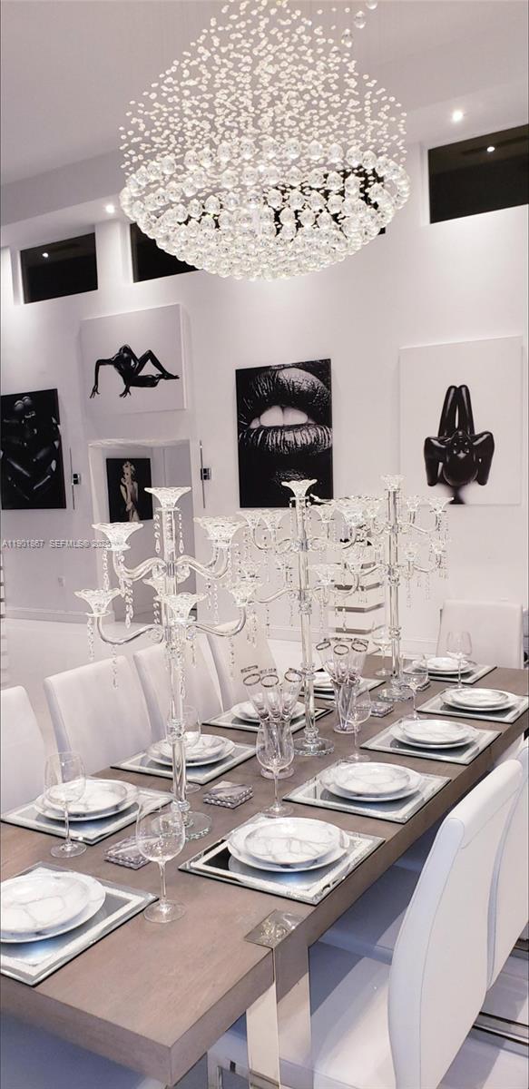 6003 Umbrella Tree Lane Tamarac, FL 33319 - Photo 9 of 22 a kitchen with a table and chairs