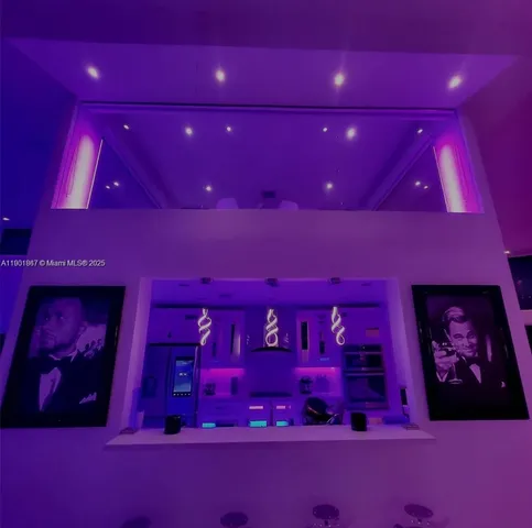 a kitchen with kitchen island a counter top space a sink stainless steel appliances and cabinets