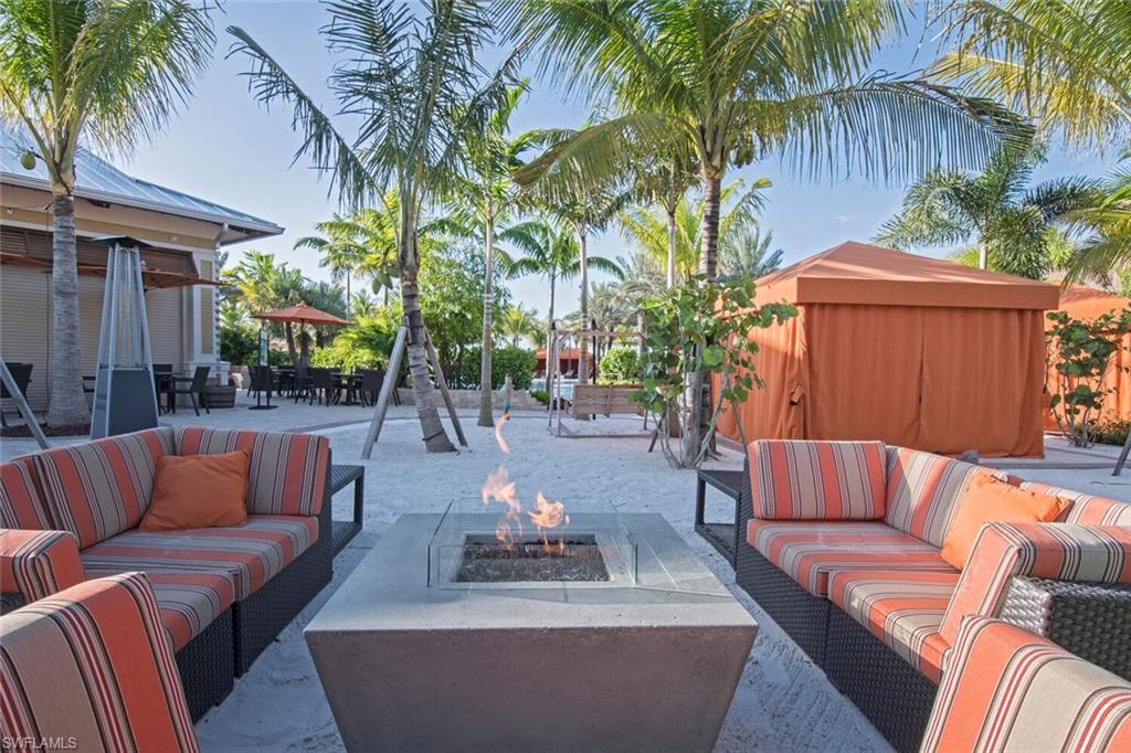 9365 Pocida Court, Unit 202 Naples, FL 34119 - Photo 37 of 40 a view of patio with couches and a potted plant