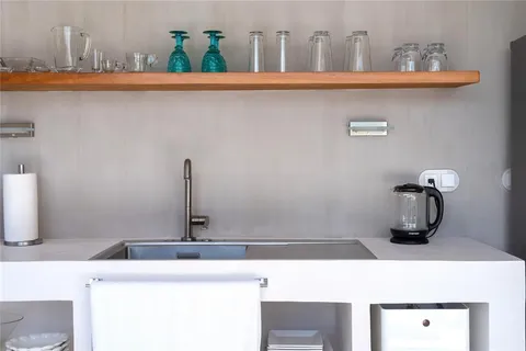 a kitchen with a sink a stove and cabinets