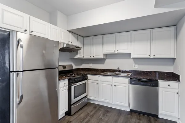 a white refrigerator freezer sitting inside of a kitchen