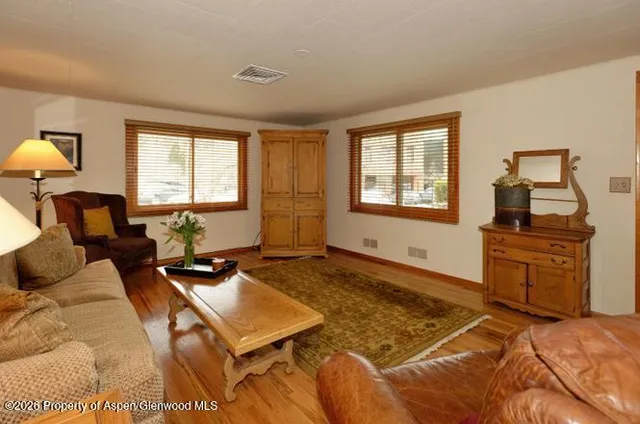 a living room with furniture a projector and a flat screen tv